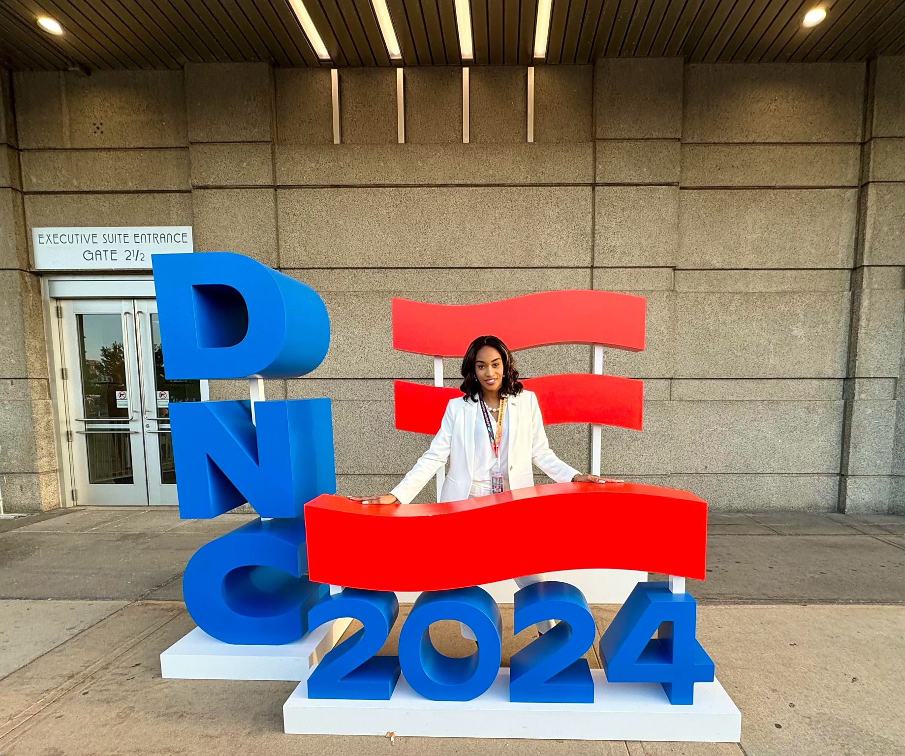 Joysaphine Waitman-Powell at the DNC 2024 sign